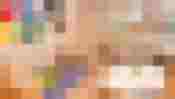 Heller Gruppenraum für Kinder mit Tischen, kleinen Stühlen, Spielteppich, Regalen und großer Fensterfront